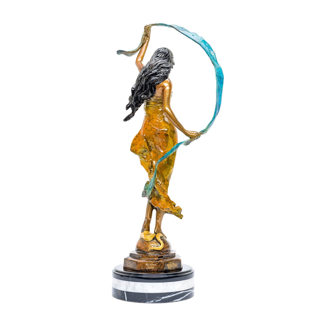 Intricate bronze artwork of a female figure with flowing ribbon details.