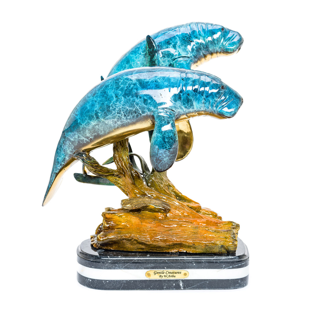 Bronze double manatee sculpture on marble base.