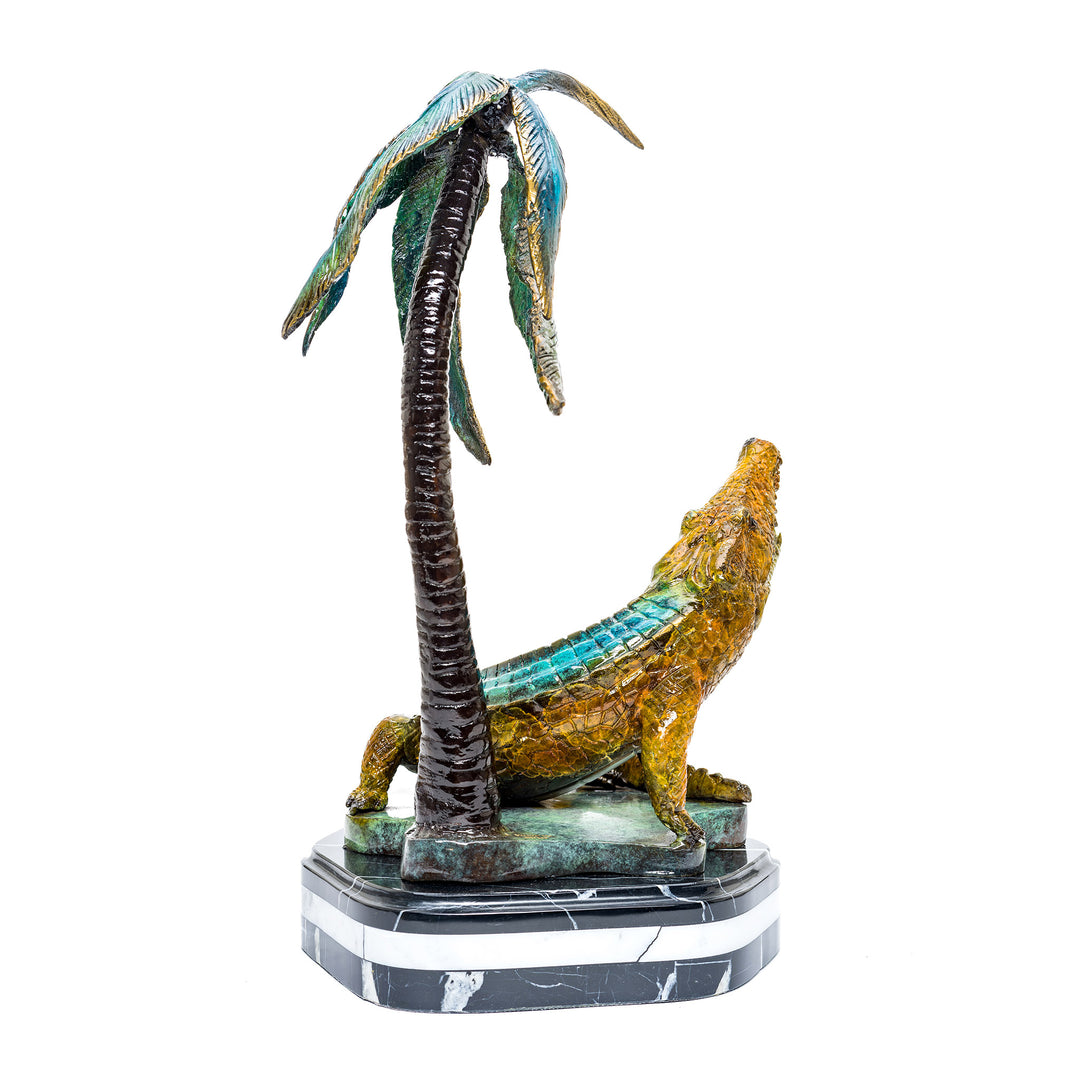 Playful bronze crocodile and palm tree statue