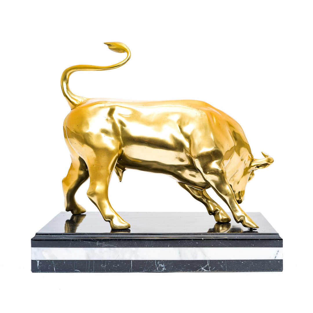 Bronze bull with dynamic posture and gold finish