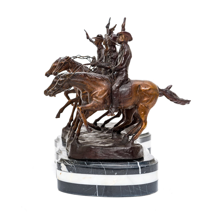 Four galloping cowboys in bronze on marble base