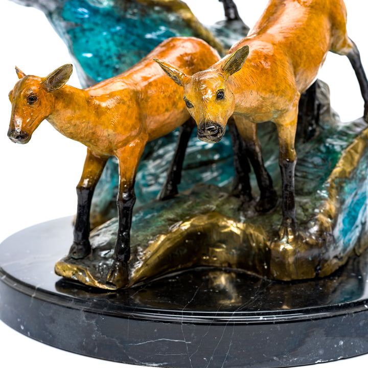 Elegant deer family statue on marble base.