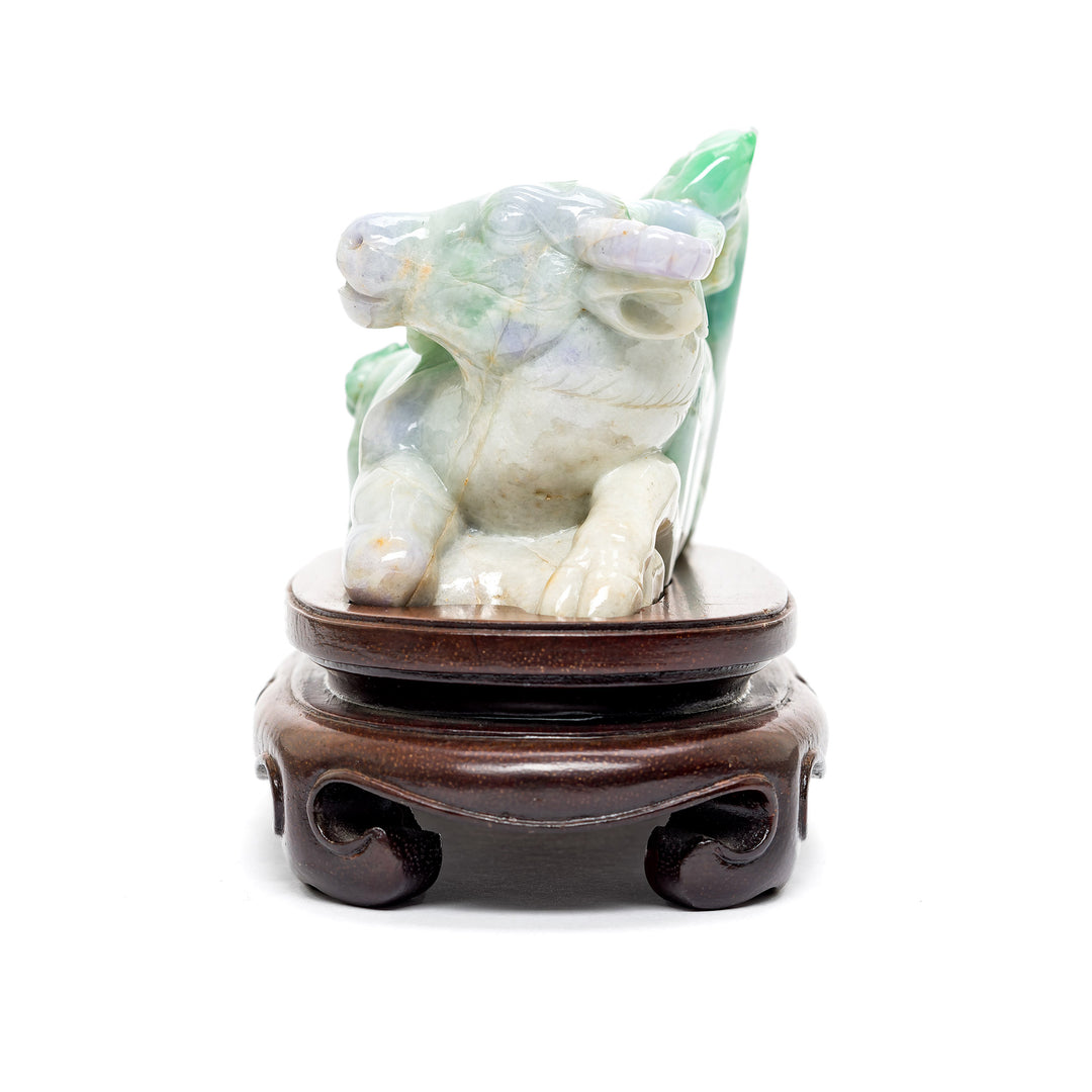 Side view of intricate jade cow sculpture