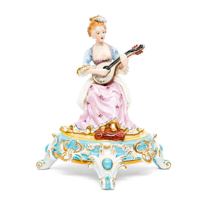 Elegant Dresden porcelain musician figurine with hand-painted details.