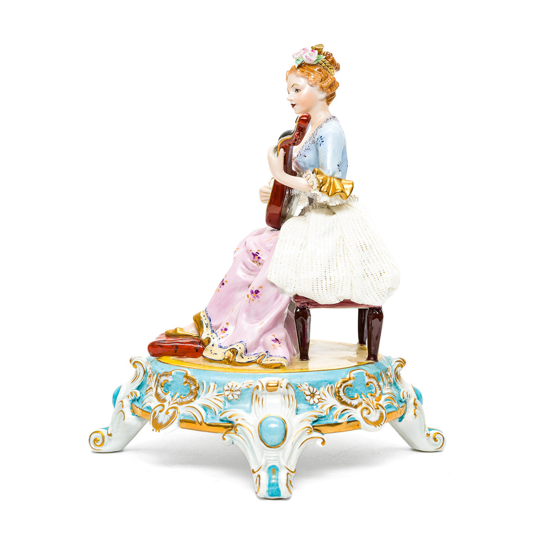 Dresden porcelain art piece depicting a young woman with a mandolin.