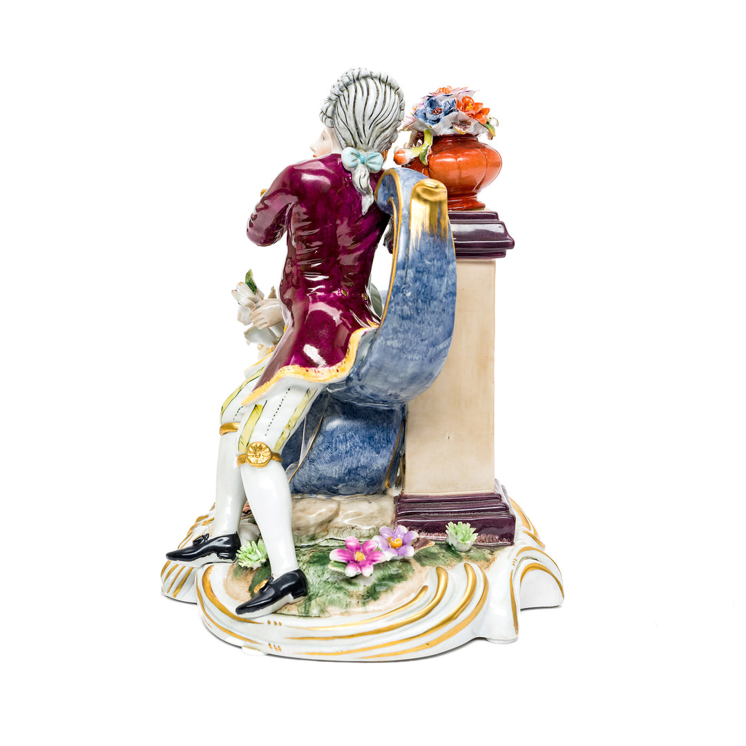 Romantic porcelain couple statue on ornate base.