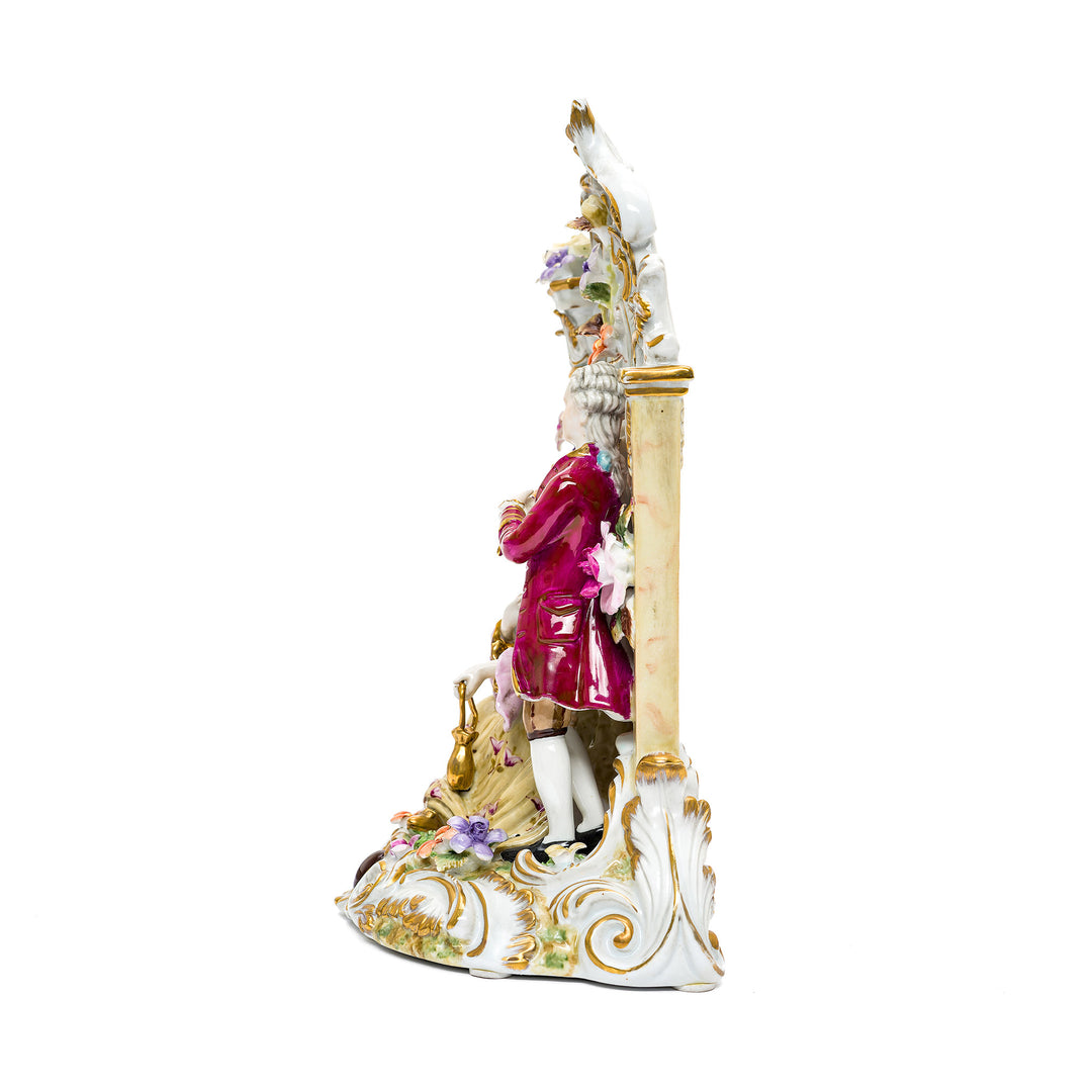 Elegant porcelain couple statue on ornate base.