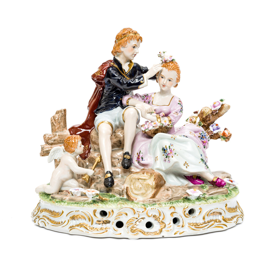 Charming Royal Porcelain Victorian couple with cherub figurine.
