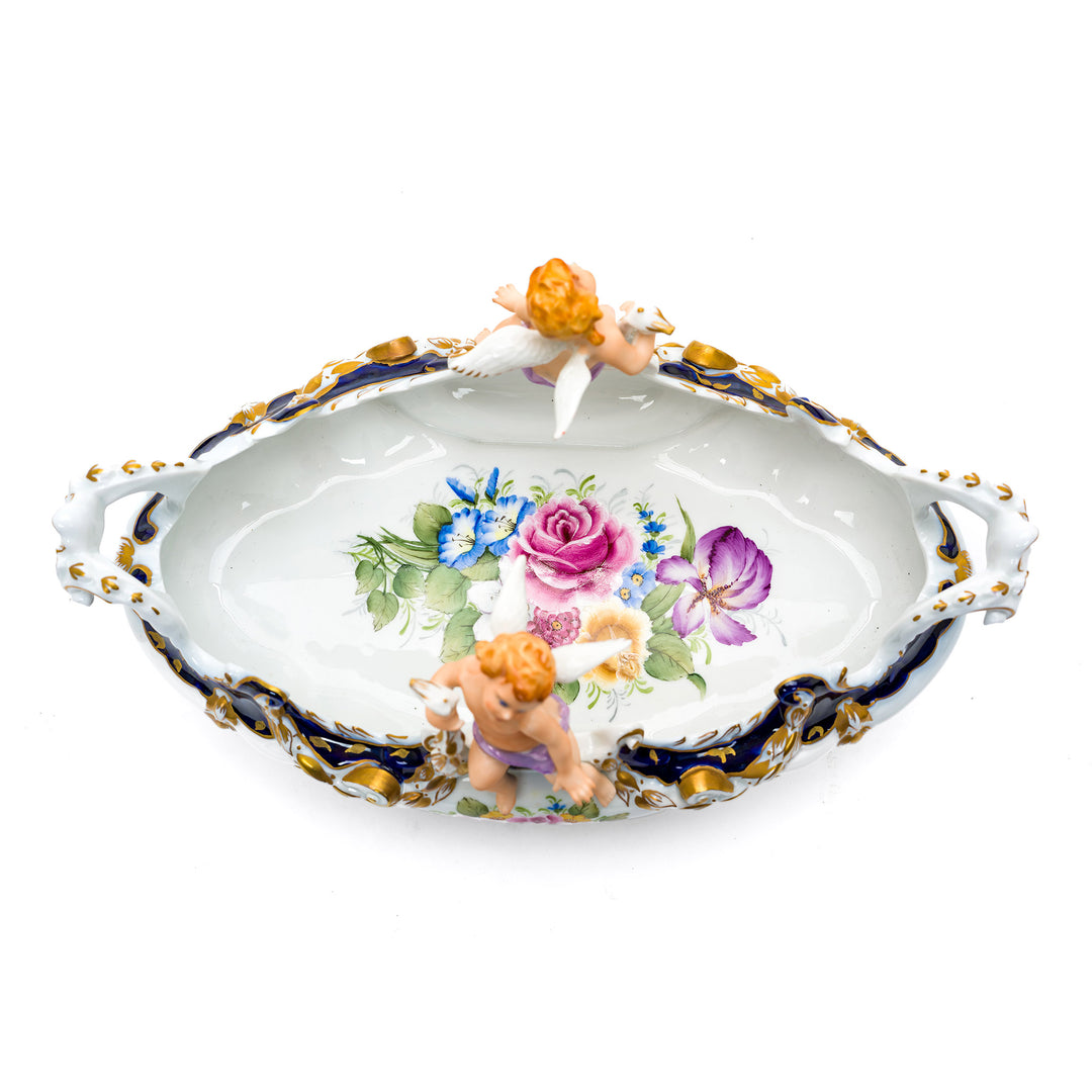 Elegant floral porcelain bowl featuring a playful cherub.