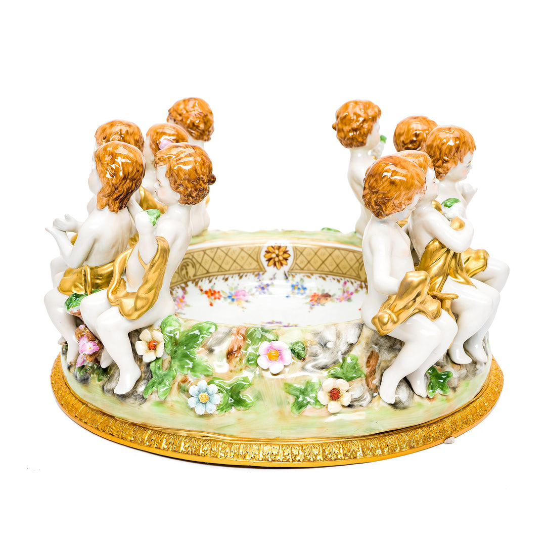 Detailed porcelain cherub centerpiece with floral bowl