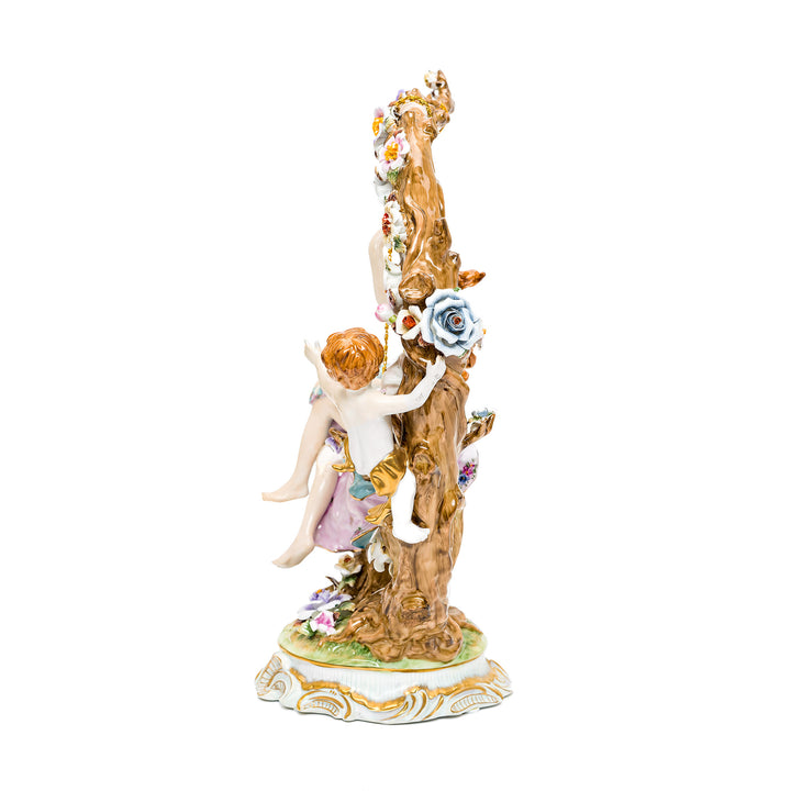 Detailed porcelain lady on swing with cherub