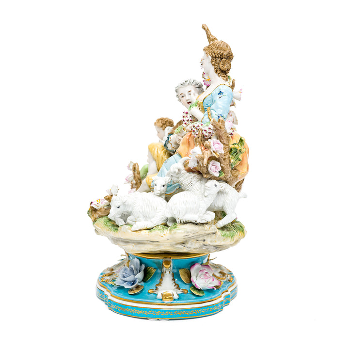 Detailed porcelain pastoral scene with figures and sheep