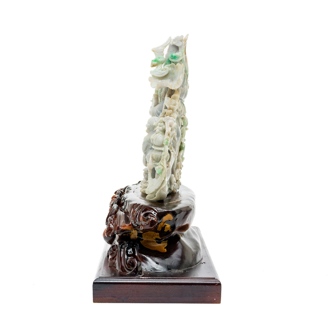Hand-carved jade Quan Yin on ornate wood base