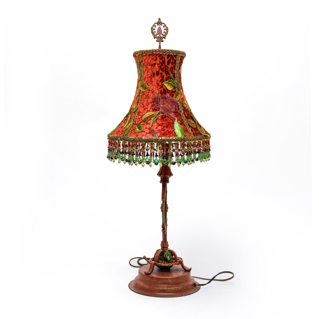 Decorative table lamp with a floral-patterned shade on a white background