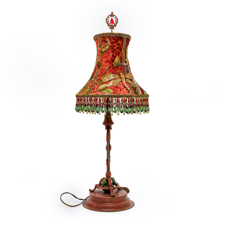 Decorative table lamp with a patterned shade on a white background