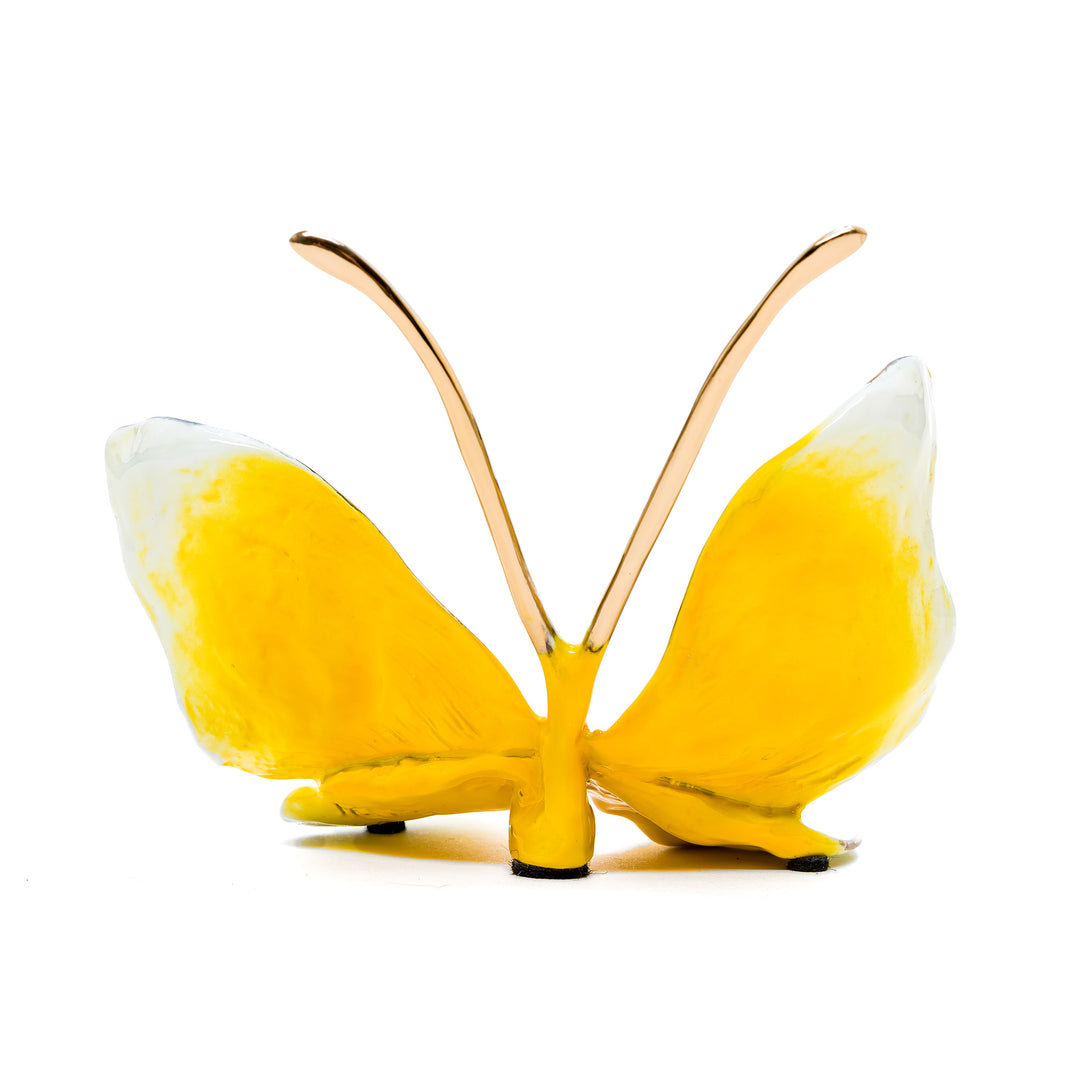 Bright yellow butterfly sculpture with soft white accents