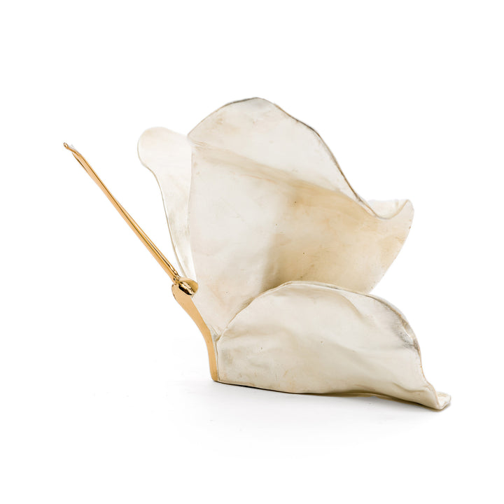 Softly luminous butterfly sculpture in white metallic patina