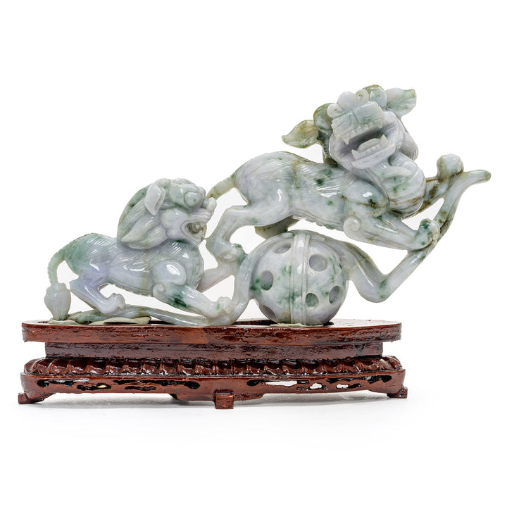 Intricate jade Foo Lions sculpture on wooden base for an antique look