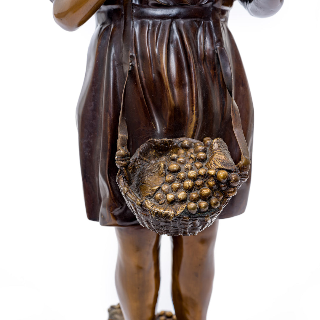 Timeless bronze girl statue holding a bird, a serene addition to home interiors