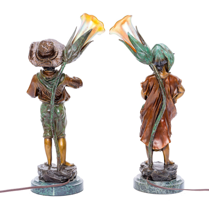 Pair of bronze lamps with nostalgic harvest figures.