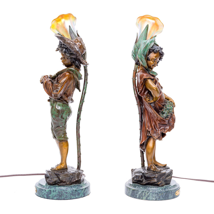 Functional bronze lamps depicting boy and girl from harvest season.