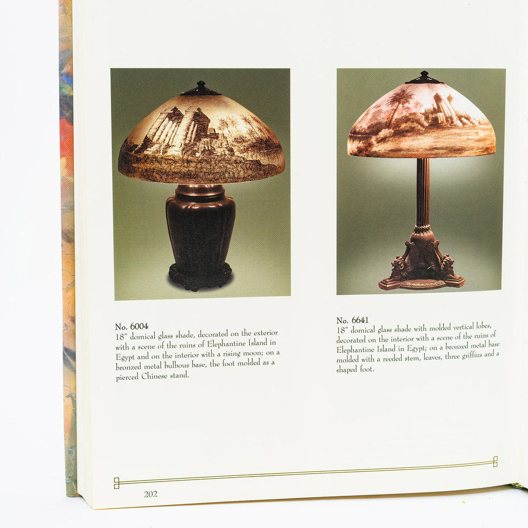 Two table lamps with decorative glass shades on a book page.