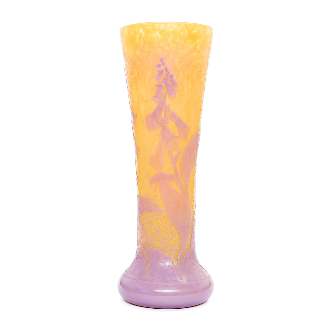 Monumental Daum Martele vase with pink floral design against a yellow background.