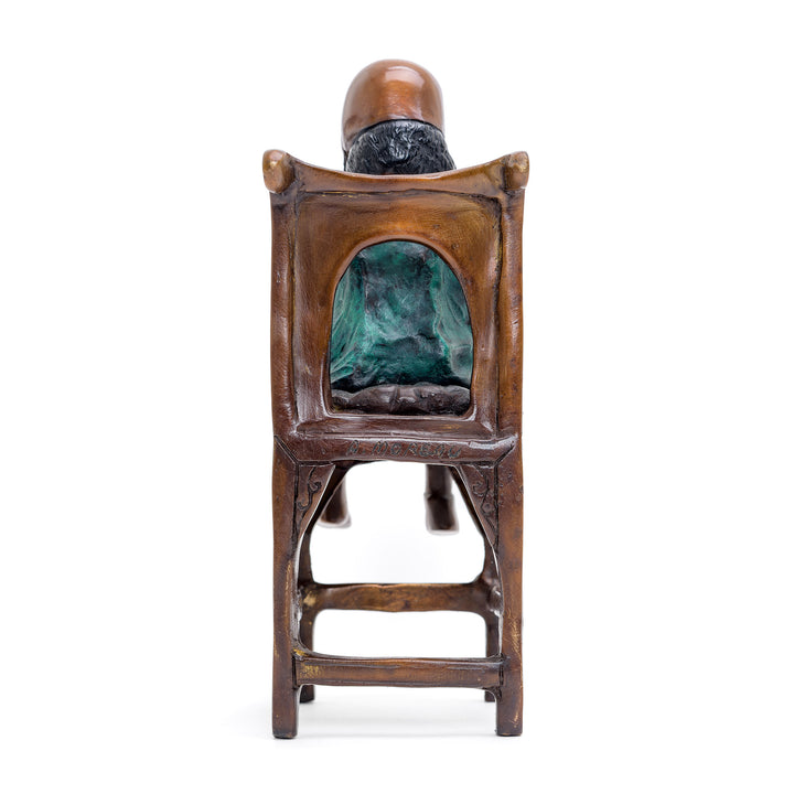 Reflective girl seated on chair, timeless bronze miniature.