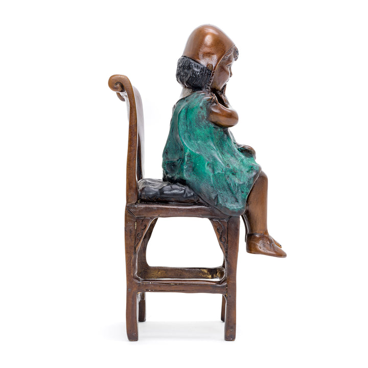 Nostalgic bronze sculpture capturing childhood innocence.