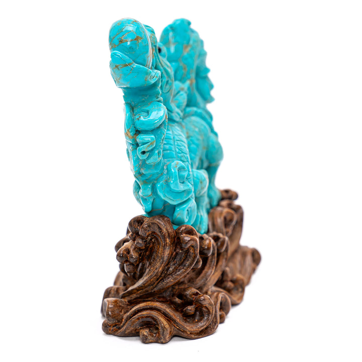 Artistic carving of turquoise dragon, a symbol of power.