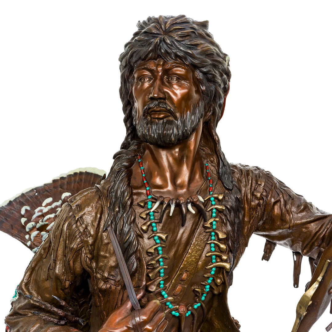 Bronze frontiersman statue with traditional attire and rifle