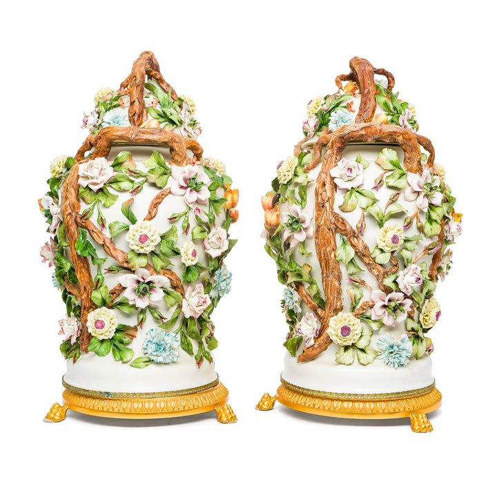 Capodimonte vases adorned with delicate flowers and branch handles.