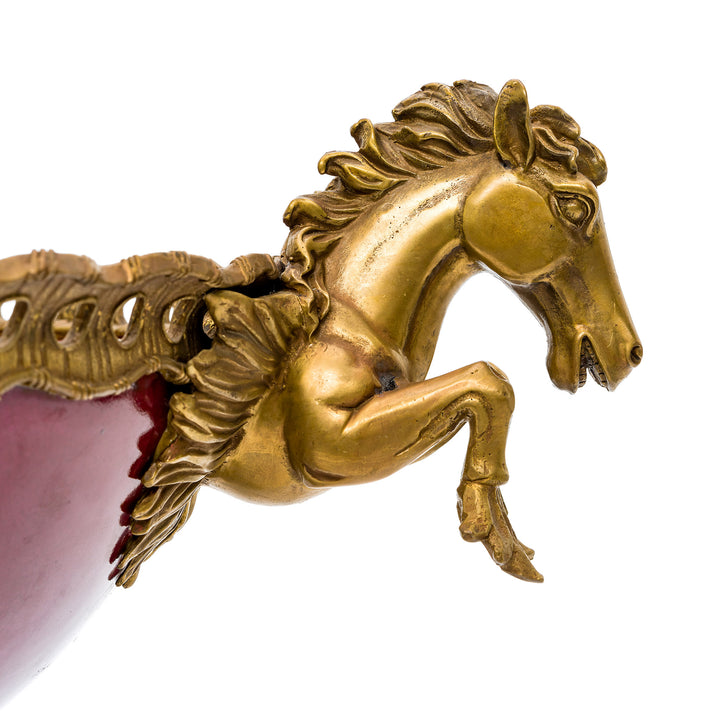 Close-up of the intricate golden detailing on the red porcelain bowl.