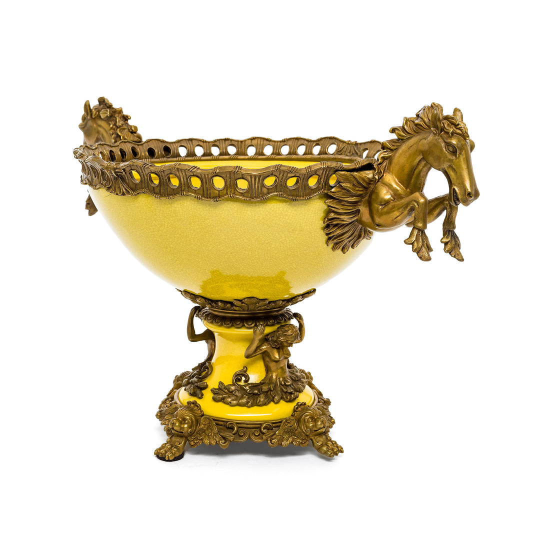 Decorative yellow bowl with leaping horse handles.