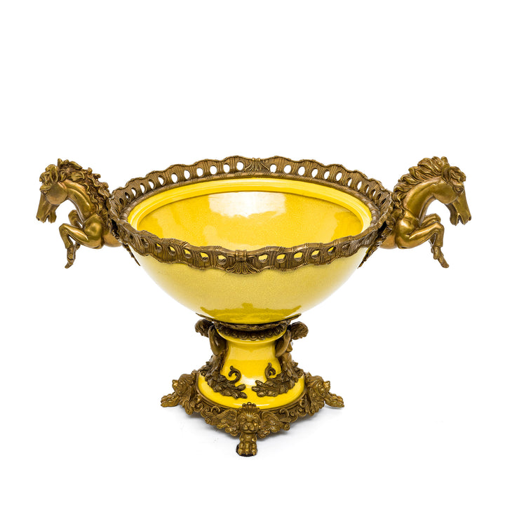 Decorative yellow bowl with regal bronze handles.