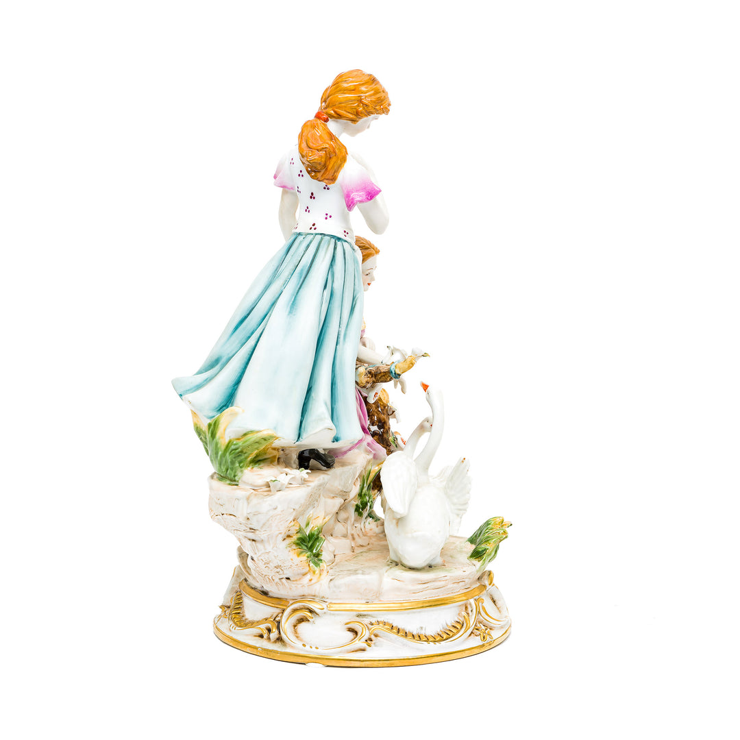Delicate flowers and golden accents on the Graceful Companions figurine.
