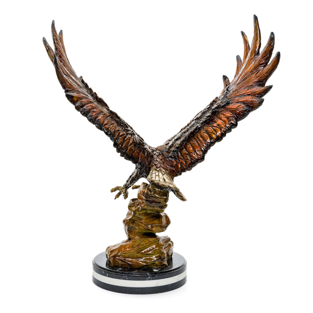 Detailed bronze eagle sculpture on a triple marble base.