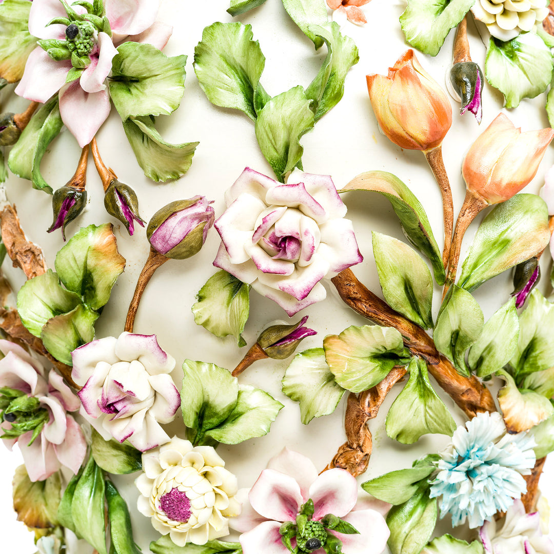 Detailed view of the hand-painted flowers on Capodimonte porcelain vases.