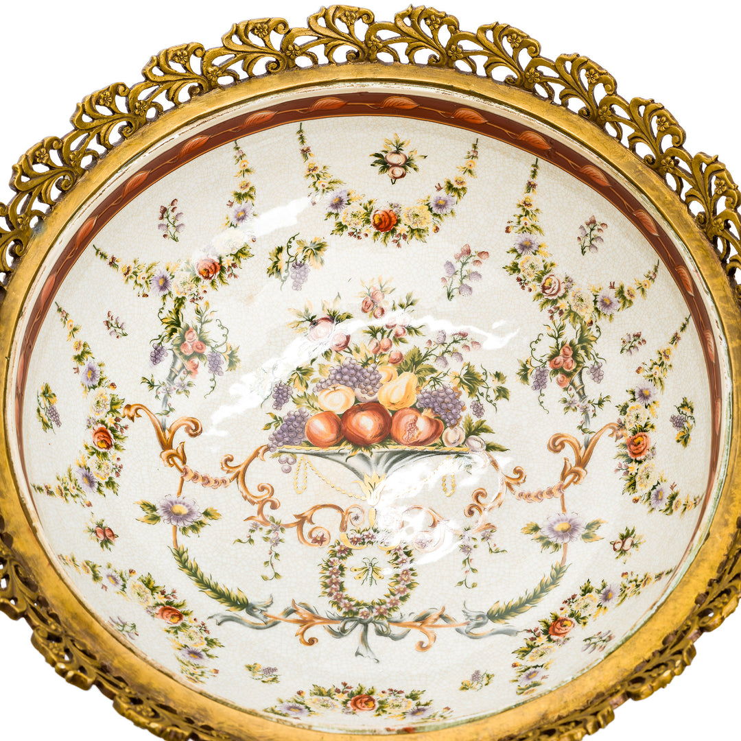 Detailed view of bronze scrolling foliate handles on the centerpiece.