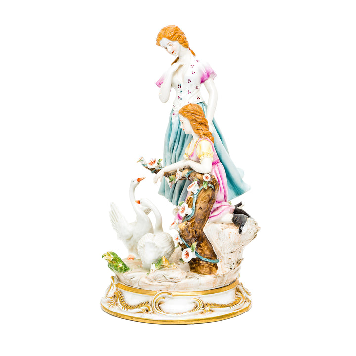 Dresden porcelain figurine of two ladies tending to swans in a serene scene.