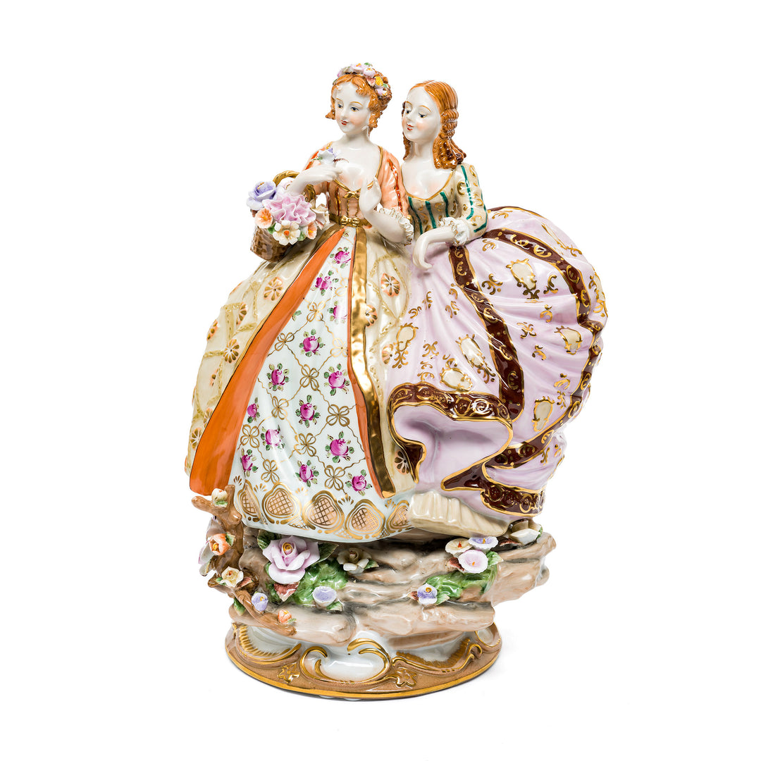 Dresden porcelain sculpture of two elegantly dressed ladies.