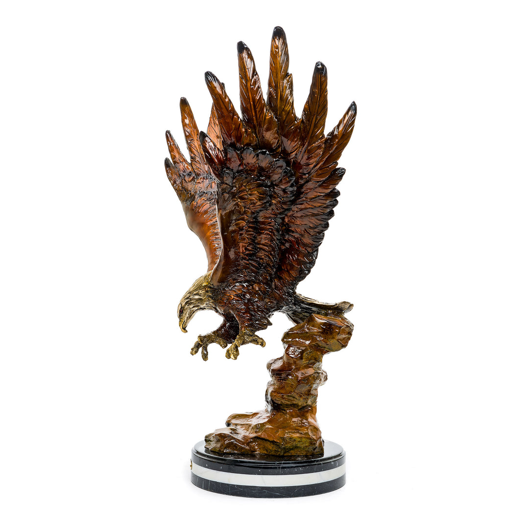 Dynamic bronze eagle in mid-flight, preparing to strike with sharp talons.