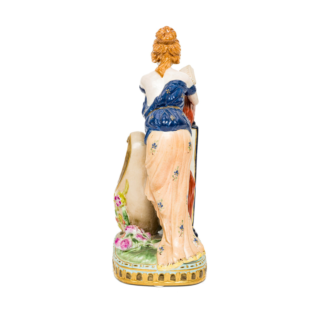 Elegant German porcelain figurine of a woman and a floral vessel.