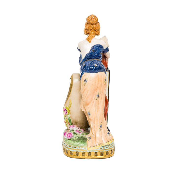 Elegant German porcelain figurine of a woman and a floral vessel.