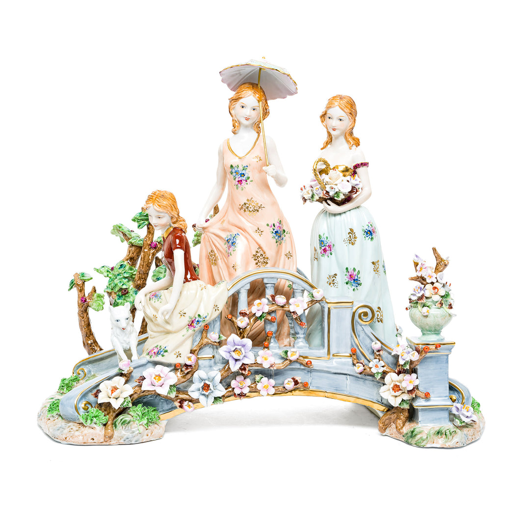 Elegant Stroll porcelain figurine featuring three ladies on a garden bridge.