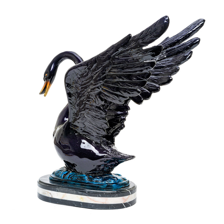 Elegant swan in bronze with wings partially spread, on a marble base.