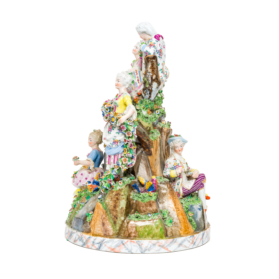 Exquisite Rococo-style porcelain figures dressed in 18th-century attire.