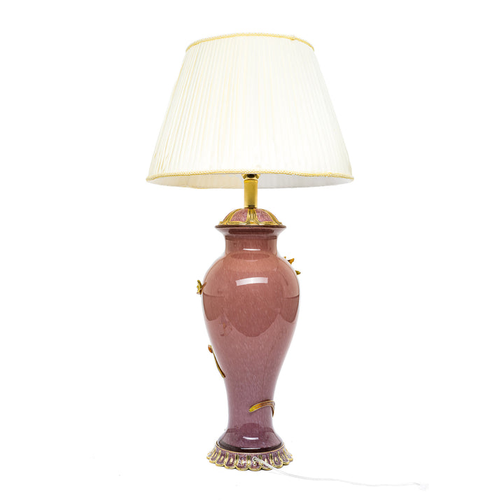 Floral table lamp with pleated cream lampshade.