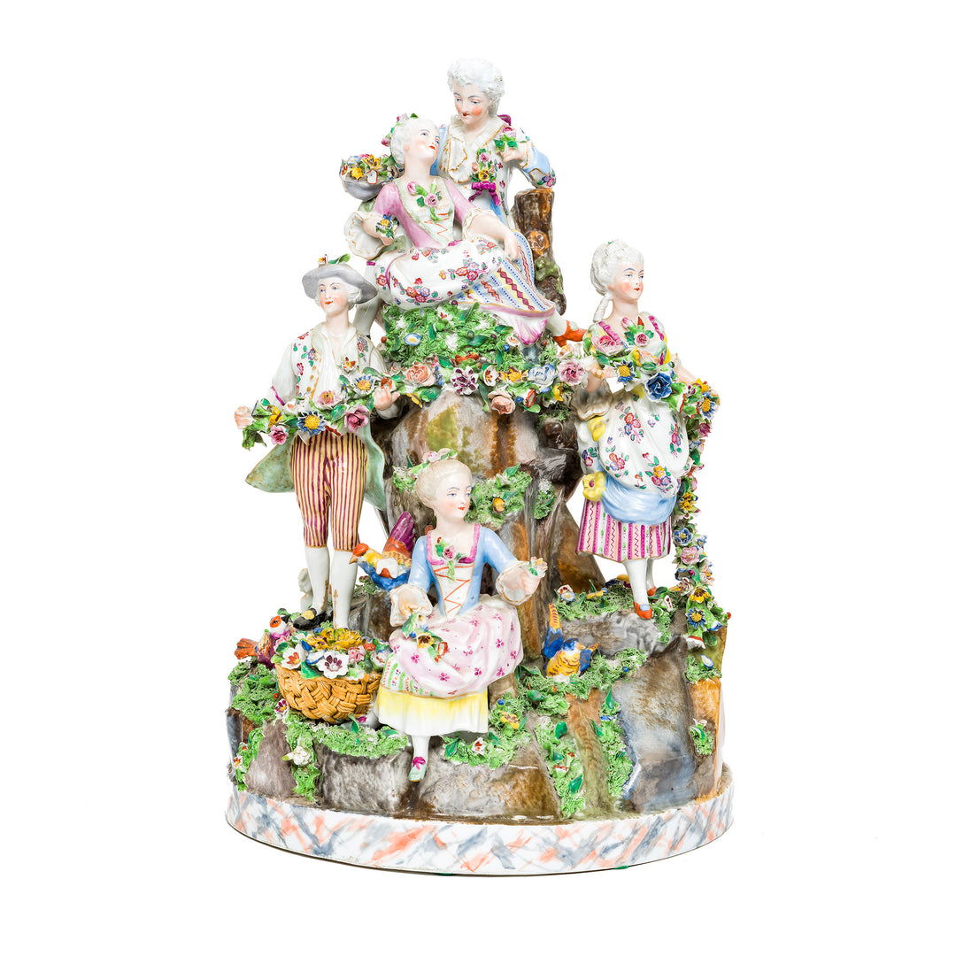 Garden Gathering Rococo figurine ensemble with aristocrats in a lush garden setting.