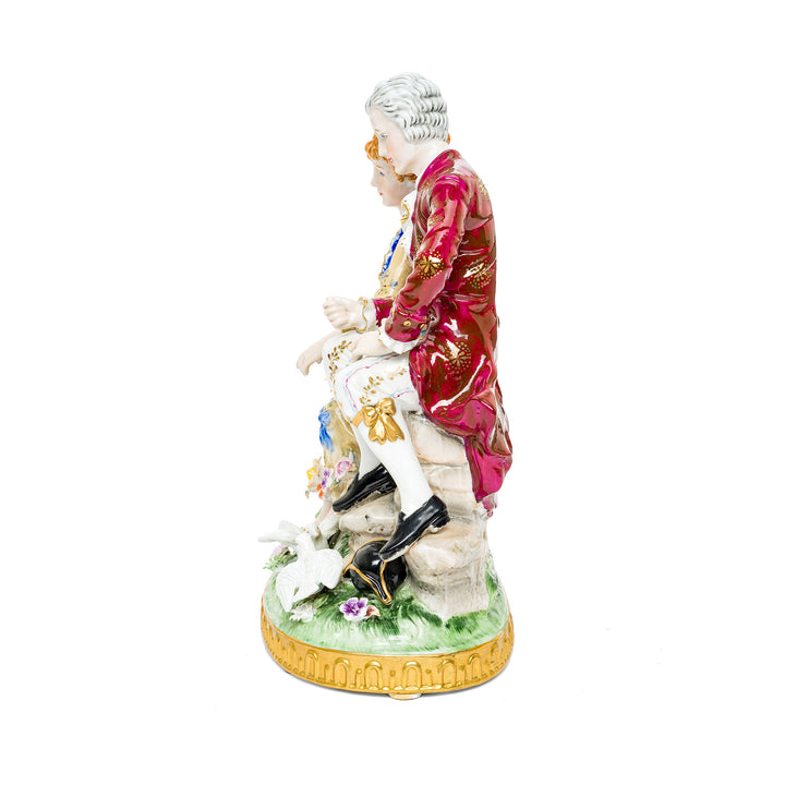 Hand-painted German porcelain couple with doves at their feet.